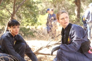 BONES:  Brennan (Emily Deschanel, R) and Cam (Tamara Taylor, L) investigate remains found on the side of a road in the "The Lost Love in the Foreign Land" episode of BONES airing Thursday, Nov. 6 (8:00-9:00 PM ET/PT) on FOX.  ©2014 Fox Broadcasting Co.  Cr:  Patrick McElhenney/FOX