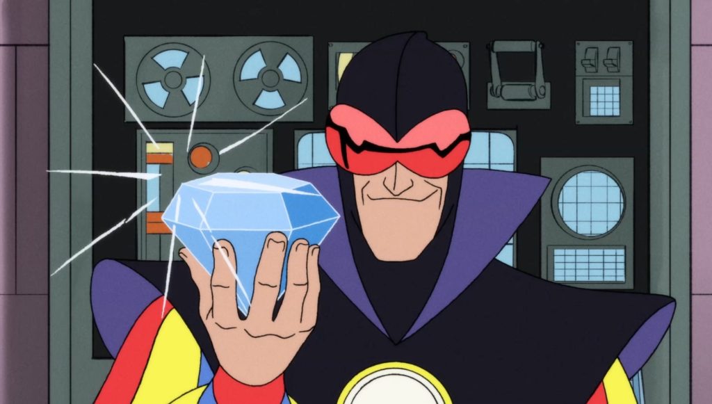 Dr. Spectro shows off his prize – an enormous diamond key to setting all of his nefarious plans in motion. Tom Kenny (SpongeBob SquarePants) gives voice to Dr. Spectro. Dr. Spectro shows off his prize – an enormous diamond key to setting all of his nefarious plans in motion. Tom Kenny (SpongeBob SquarePants) gives voice to Dr. Spectro.